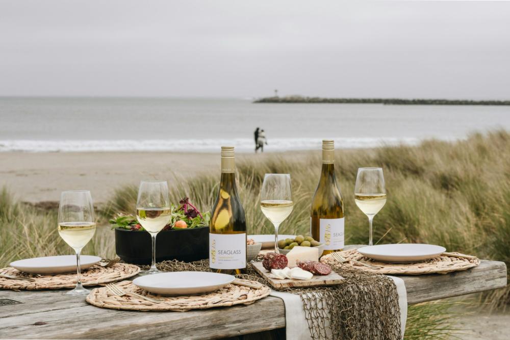Wine bottles and glasses on the beach