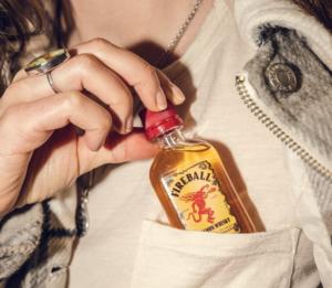 fireball whiskey in woman's front pocket