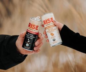 RISE cold brew cans cheersing 