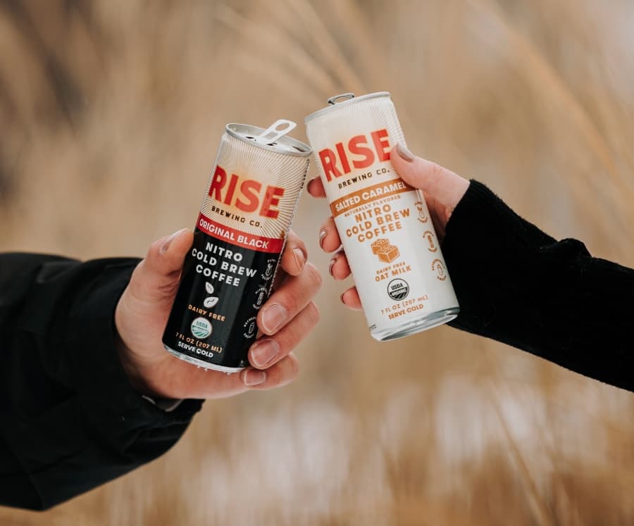 RISE cold brew cans cheersing